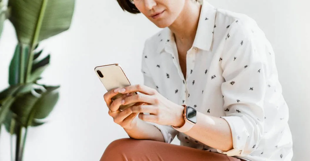Woman using her phone for work