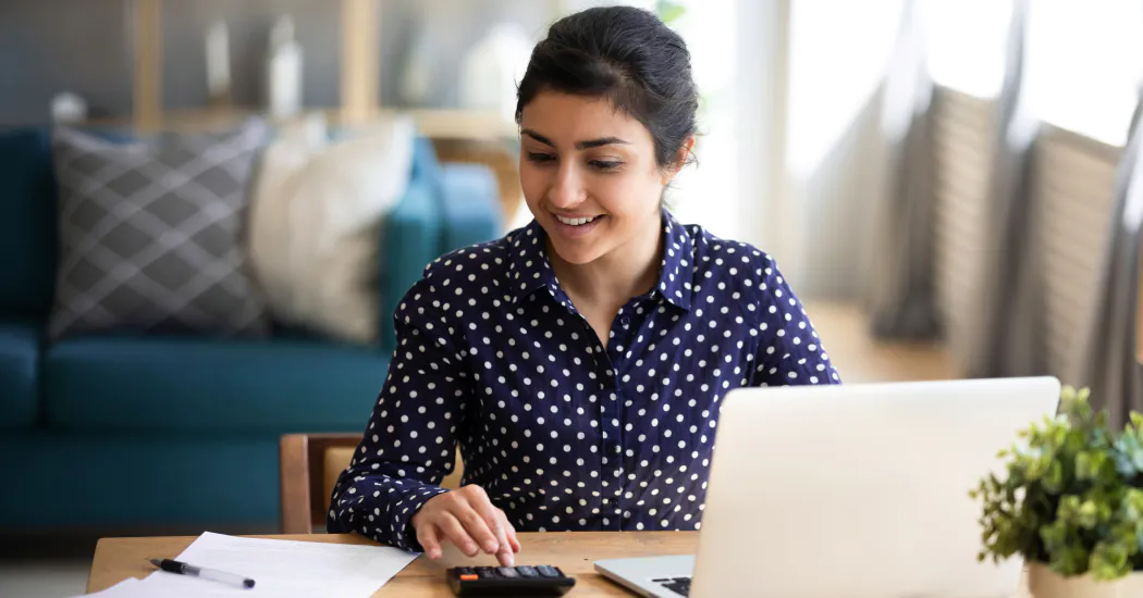 A young woman calculates her house insurance