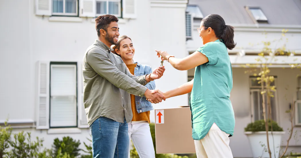 A landlord passes keys to their tenants